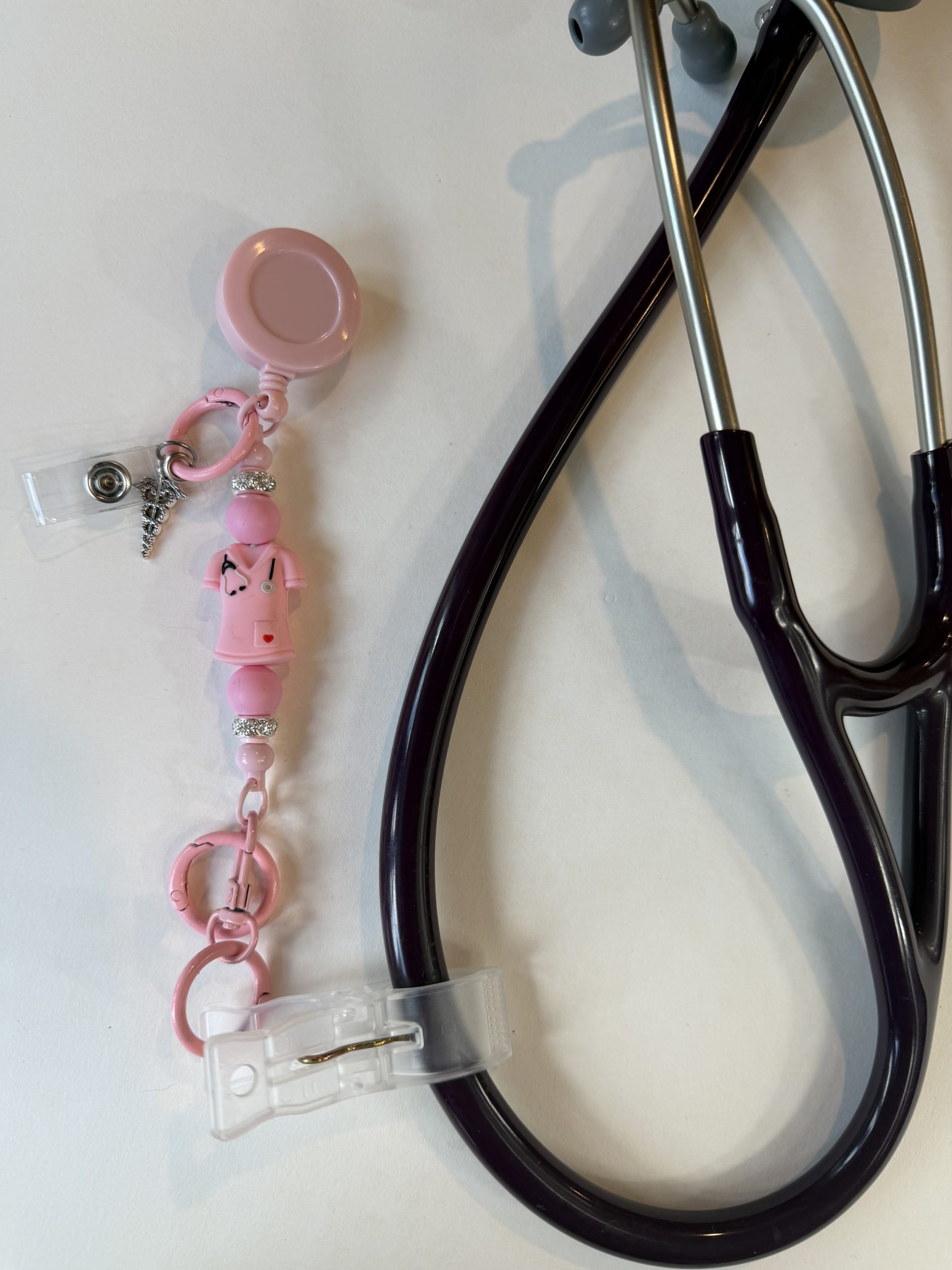 Pink scrub top clip with caduceus charm